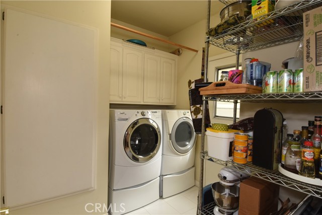 Nice laundry room off the kitchen has door to side yard.