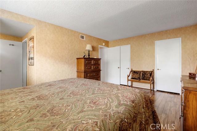 Main bedroom showing 2 separate closets and bathroom door at left.