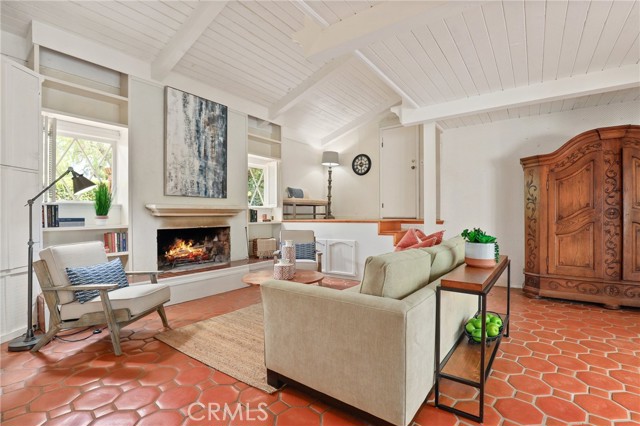 Warm and cozy fireplace in the Family room with Cathedral ceilings and platform door to the attached garage in the background