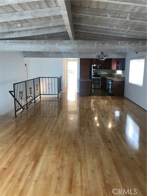 Nice open upstairs area with high wood bean ceilings.