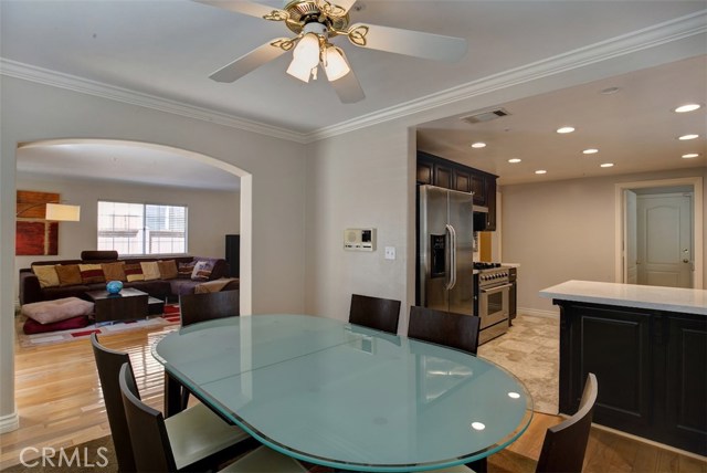 Dining room with crown molding, ceiling fan and Maple floor