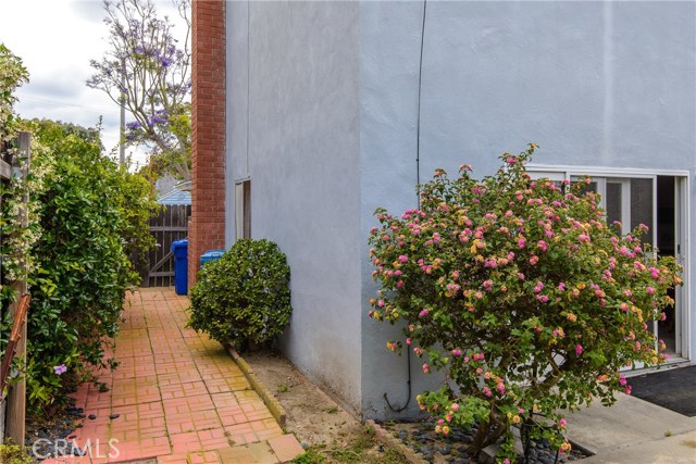 North side of the house with bricked walkway and flowering bushes!