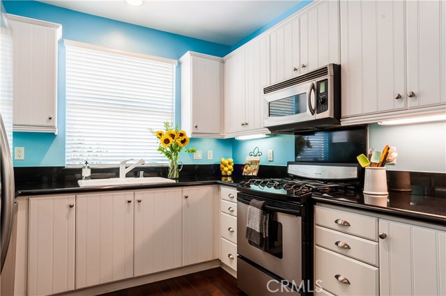 Stainless appliances include a Kitchen Aid stove.