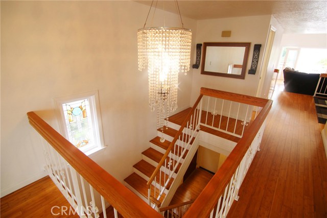 Top of the stairs features a beautiful glass chandelier sure to impress.