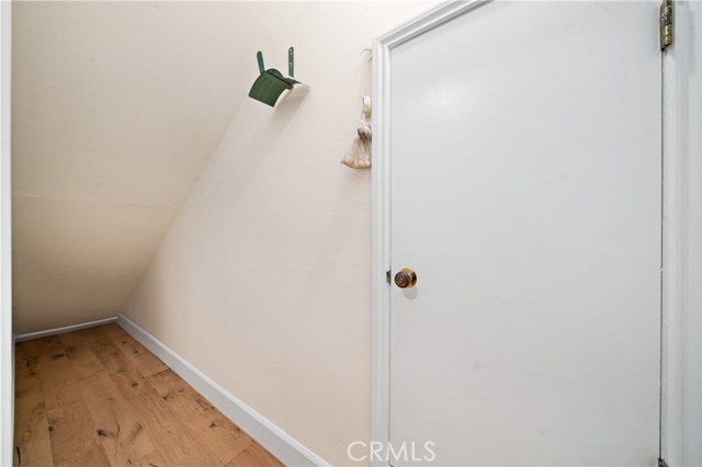 Large storage under the stairs and doorway that leads to additional storage in large walk space under the house.