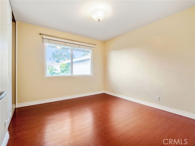 Bedroom #2 with hardwood floors and custom closet built ins.