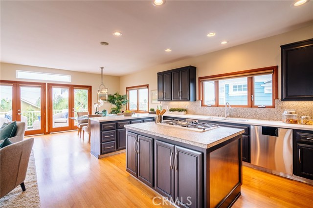 Kitchen with breakfast area opens to family room and ocean view deck