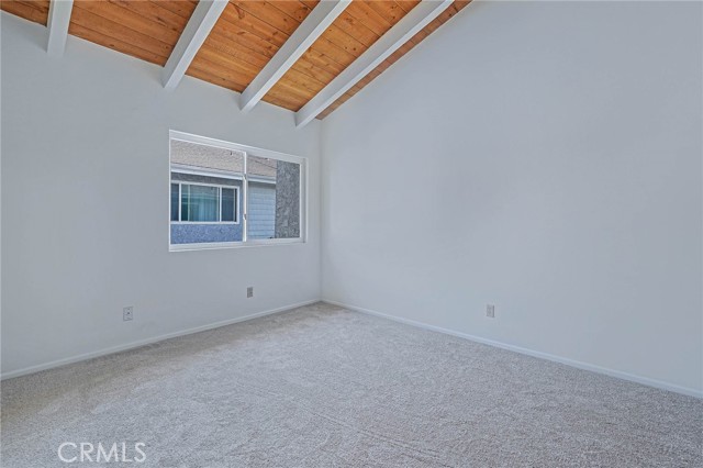 Bedroom 1, both Bedrooms have Beams with high Wood Ceilings