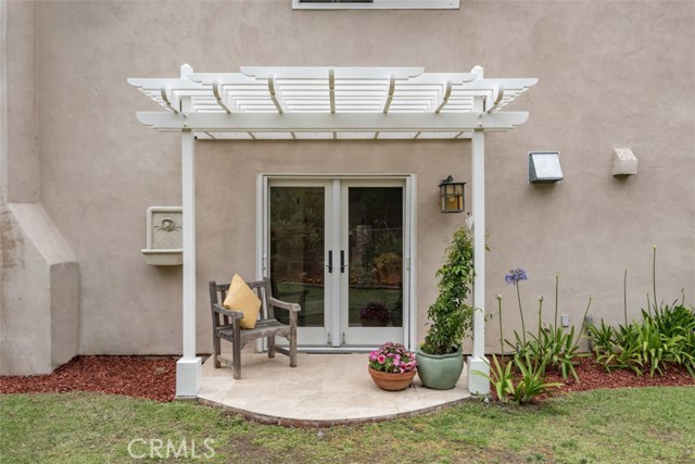 Custom built Pergola outside kitchen leading to side yard.