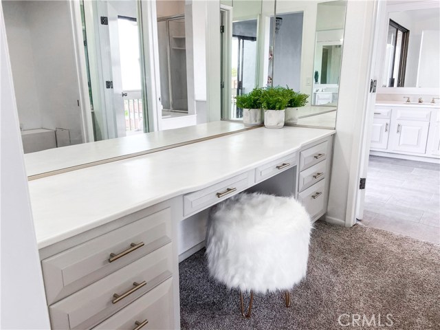 Master vanity with plenty of light and storeage and floor to ceiling mirrors