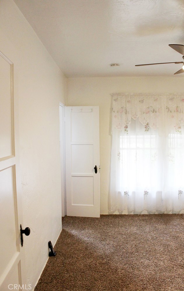 Bedroom 1 with ceiling fan and cedar closet