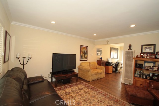 Unit B living room with dining area beyond.  Crown moldings, recessed lighting, super clean!