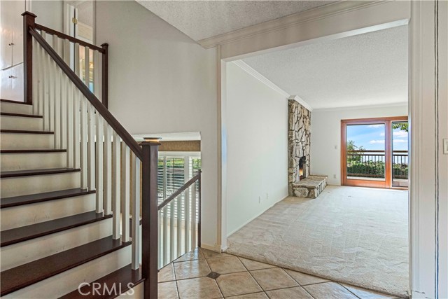 Living Room entry looking toward fireplace, view and deck