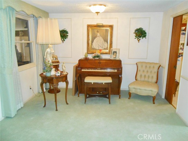 Formal Dining Room Currently Used as a Music Sitting Area Open to Formal Living Room. Did you Catch the  Pocket Door Leading to Kitchen to the Right and the Window overlooking the Enclosed Patio to left?