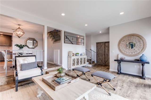 Enter the living room, filled with natural light which is spacious enough to entertain and features sliding glass doors that lead to a large patio that over looks the park