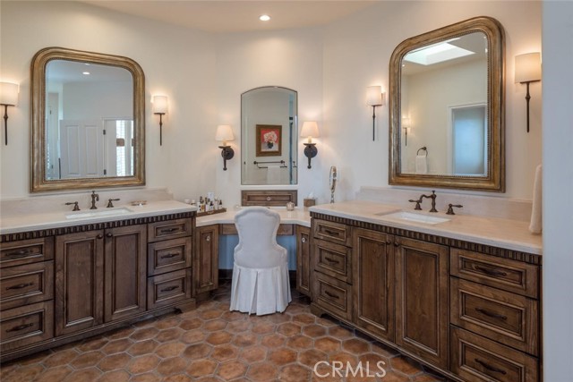 primary bath retreat with dual sinks and dressing area