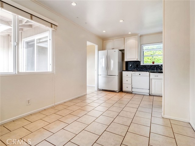 The kitchen with a large breakfast nook and ample cabinetry and pantry space.