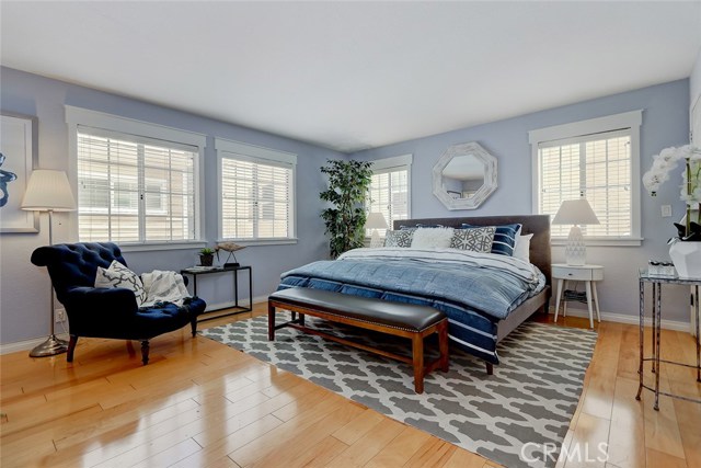 Spacious master bedroom with custom window treatment.