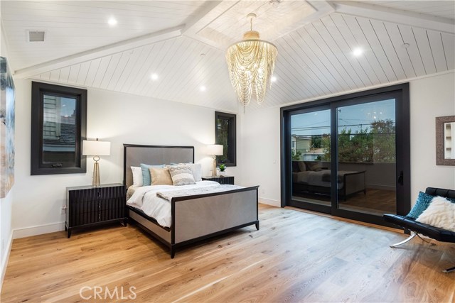 The Master Bedroom. An ample 16'x16', the Vaulted Ceiling with a custom tongue in groove treatement and an 8' sliding patio door provide a feeling of spaciousness.