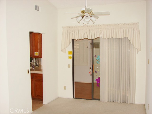 ANOTHER VIEW OF DINING ROOM AND KITCHEN ENTRANCE WITHOUT FURNISHINGS.