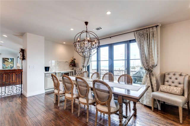 Here you can see the bar with beverage center and counter space for your mixologist. Behind the table are doors to the 3rd terrace on this level with enough room for a bbq or to take your dining experience outside.