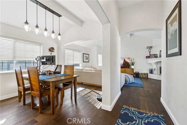 Open concept upstairs including dining area, kitchen, living room and balcony