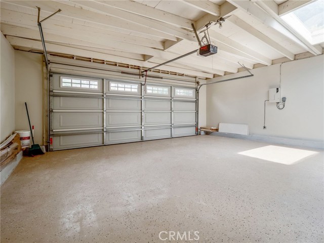 Two Car Garage with direct access to the house; epoxy floor finish; also has door to grass side yard.