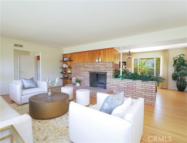 View from living room with fireplace open to dining room.