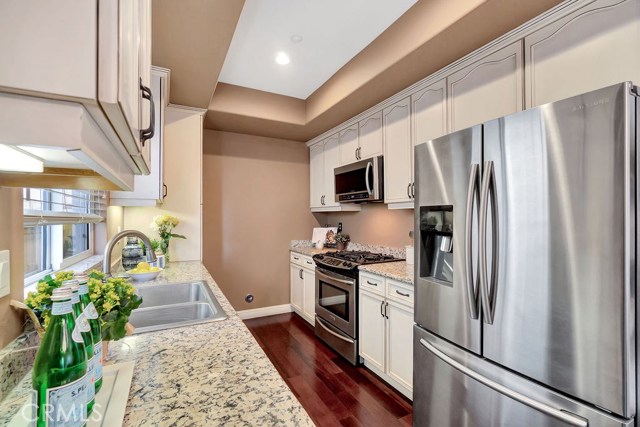 Kitchen has custom stained maple cabinets, double sinks, new microwave, stove and oven as well as newer stainless steel refrigerator (included). Kitchen has custom stained maple cabinets, double sinks, new microwave, stove and oven as well as newer stainless steel refrigerator (included).