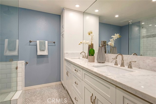 En-suite master bath with carrera marble countertops, dual sinks, tons of cabinet space, huge walk-in shower with beveled subway tile, dual shower heads including rain shower. En-suite master bath with carrera marble countertops, dual sinks, tons of cabinet space, huge walk-in shower with beveled subway tile, dual shower heads including rain shower.