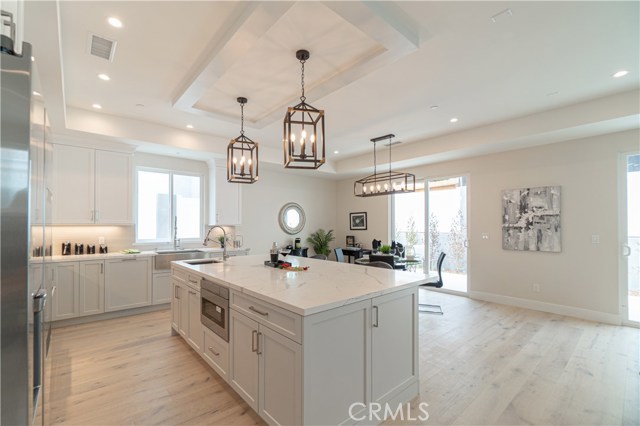 Kitchen, Kitchen Island, & Dining Area. Access to Backyard through Sliding Doors.