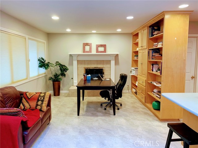 Family room with fireplace & built in bookcases.