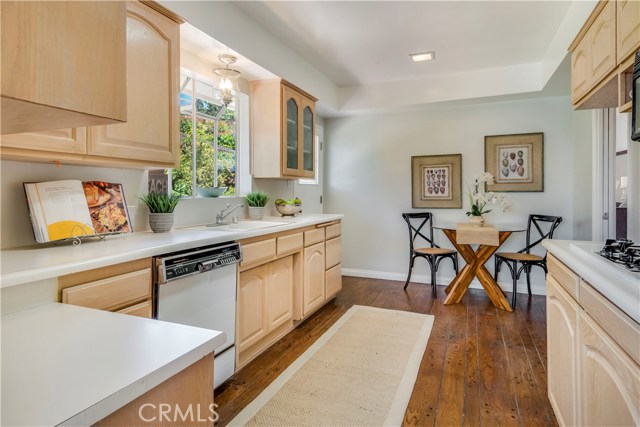 Kitchen with breakfast nook and garden window has hardwood floors and new light fixtures