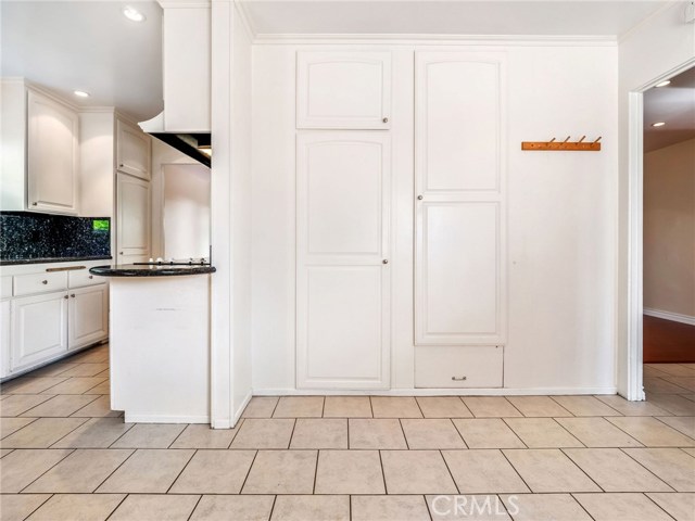 The kitchen with a large breakfast nook and ample cabinetry and pantry space.