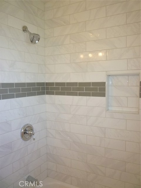 Hallway bathtub and shower combination.