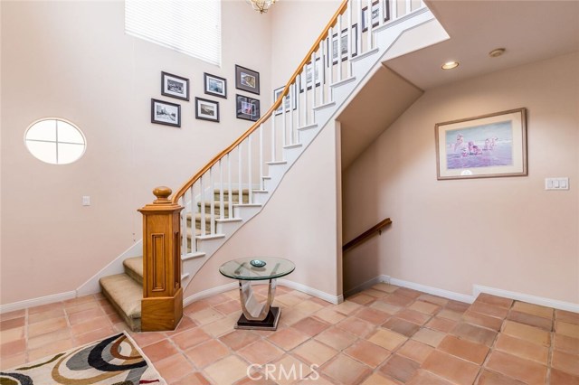 Entry with stairwell to the second floor and opening from downstairs garage and utility room