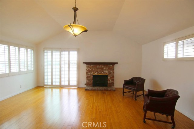 Enjoy an evening view of the eastern city lights from your living room balcony while staying warm around the cozy brick fireplace.