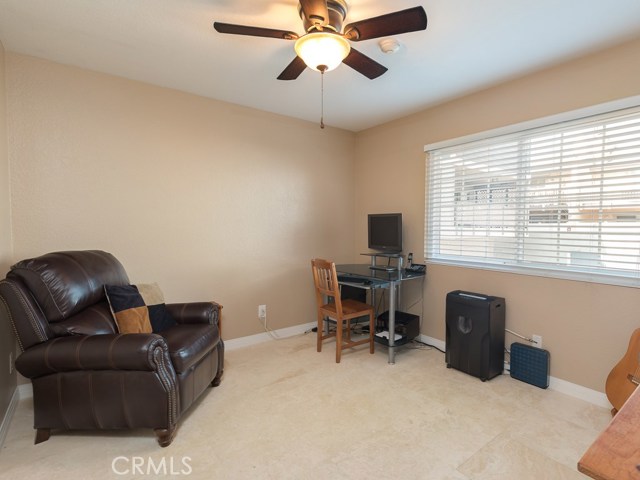 Bedroom on entry level with travertine floor, currently being used as an office.