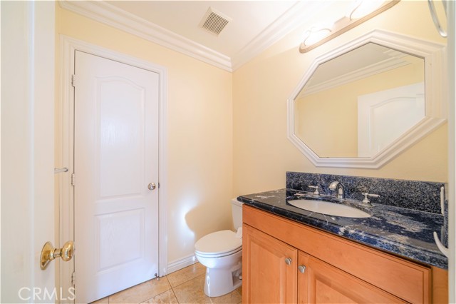 Powder room located across from laundry room, closet door leads to large storage area