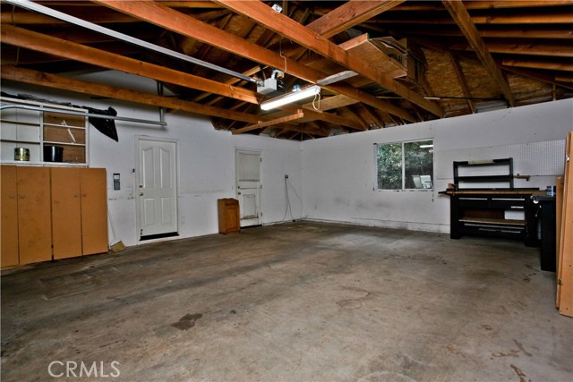 Plenty of space in the garage with a man door leading to back yard and an auto garage door opener