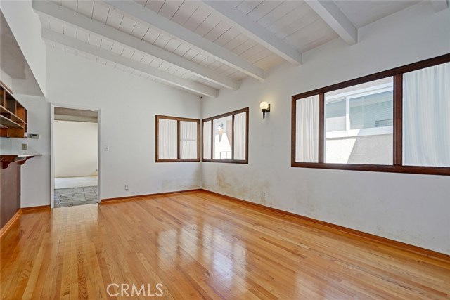 This is from the south side of the home looking into the family room area off of kitchen. Original wood floors and the home is being sold as is. Bring your vision and make this home your own style and design.