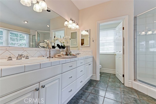 Master bathroom with dual sinks and separate toilet room.