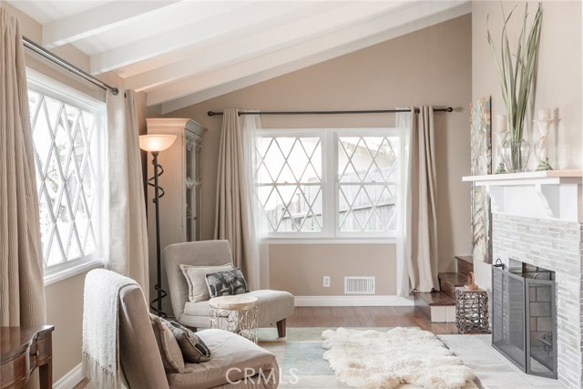 Living Room Features Fireplace with Beveled Travertine Tile Work