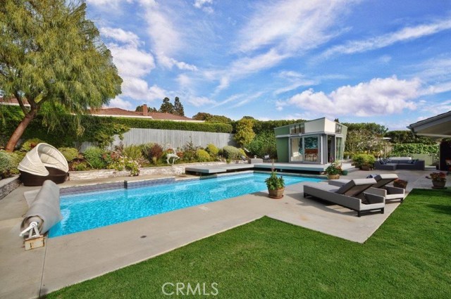 Beautiful Landscaped Backyard with Grassy Area & Pool