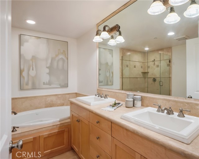 Spacious primary en-suite bathroom with recessed lighting.