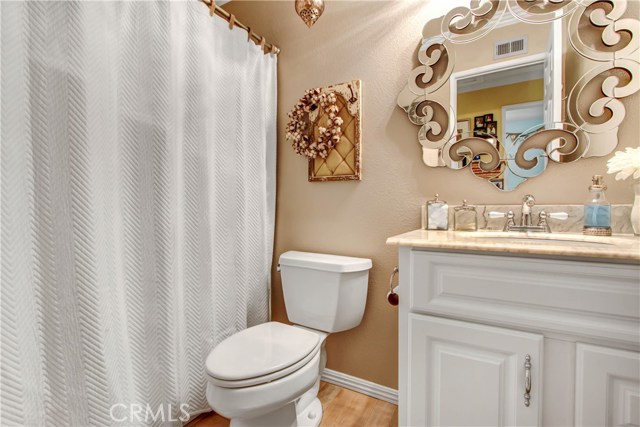 The hallway bathroom includes new vanity, custom mirror, updated fixtures, new flooring and baseboards