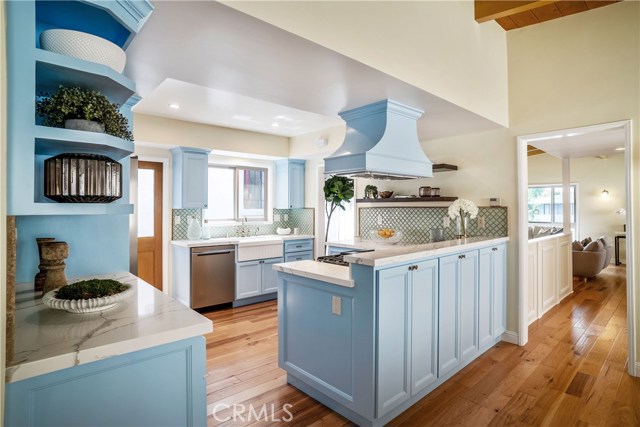 There is a multi drawer pantry inside those cabinet doors.. no detail sparred for a cook. Everything you see including the quartz countertops and recessed lighting, the wide plank hardwood floors and new appliances is thoughtfully placed and works in concert with both the living room areas and dining room/great room area.