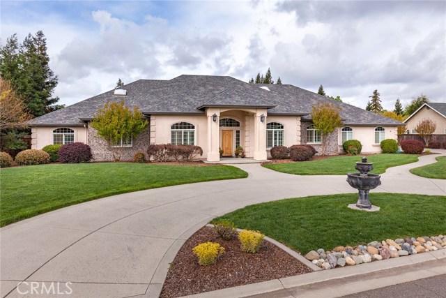 Front view of home with circle driveway, water fountain, nice walk-ways and entry way.