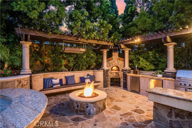 outdoor kitchen with swim up bar, Beer tap, wood burning pizza oven.