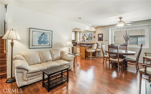 Upstairs living room, dining area, and breakfast bar looks into the open kitchen.